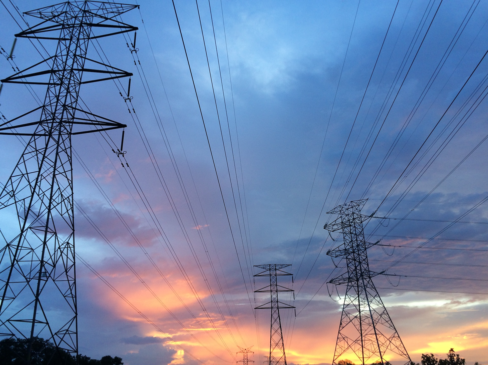 Electrical power lines with sunset behind 